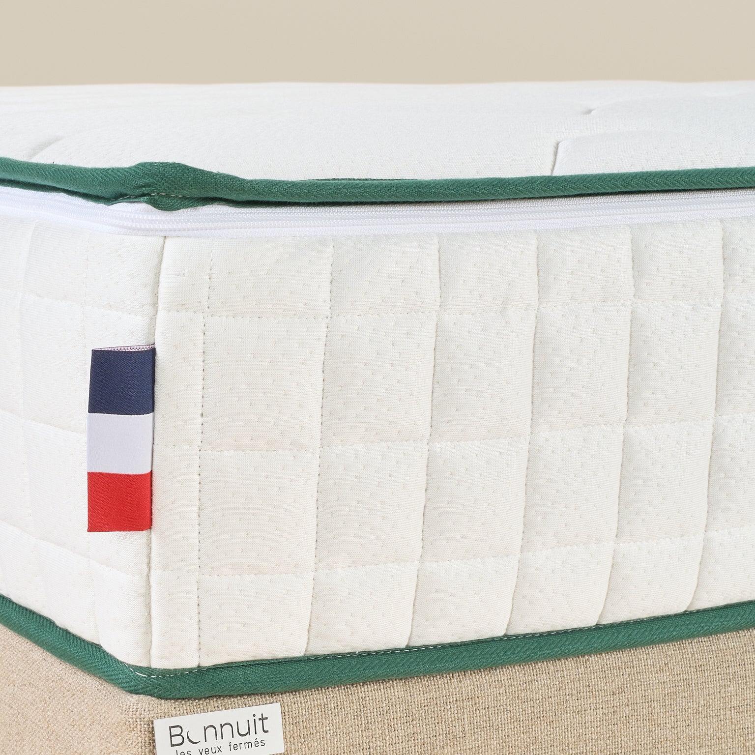 Zoom sur le coin du matelas Le Naturel avec drapeau bbr Bonnuit et liseré vert en finition