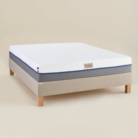 Matelas L’Authentique Bonnuit en mousse ferme avec accueil mémoire de forme, vue 3/4 avec housse bicolore et logo brodé sur lin
