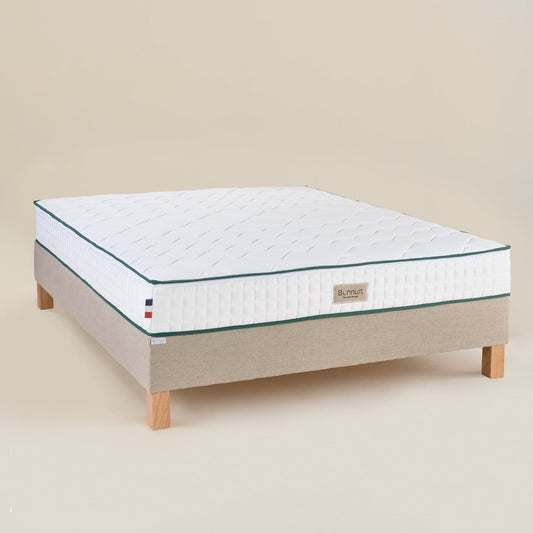 Matelas Le Naturel en latex 100 % naturel vu en angle, housse bicolore claire et liseré vert visible
