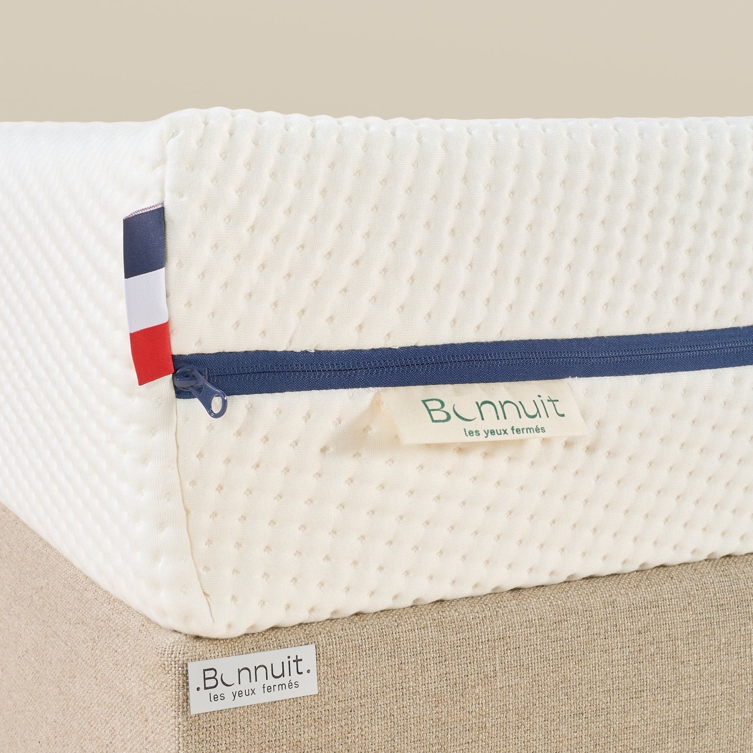 Zoom sur le coin du matelas Le Pratique avec drapeau brodé Bonnuit et finition liseré bleu